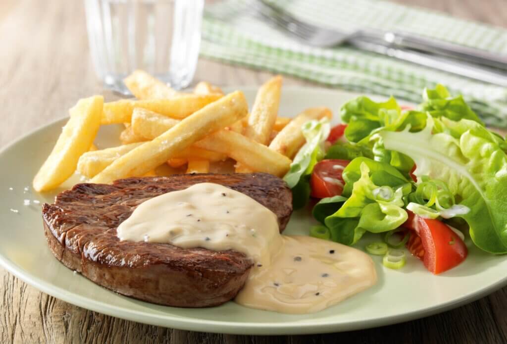 Classic belgian peppercorn sauce over steak, served with fries and salad